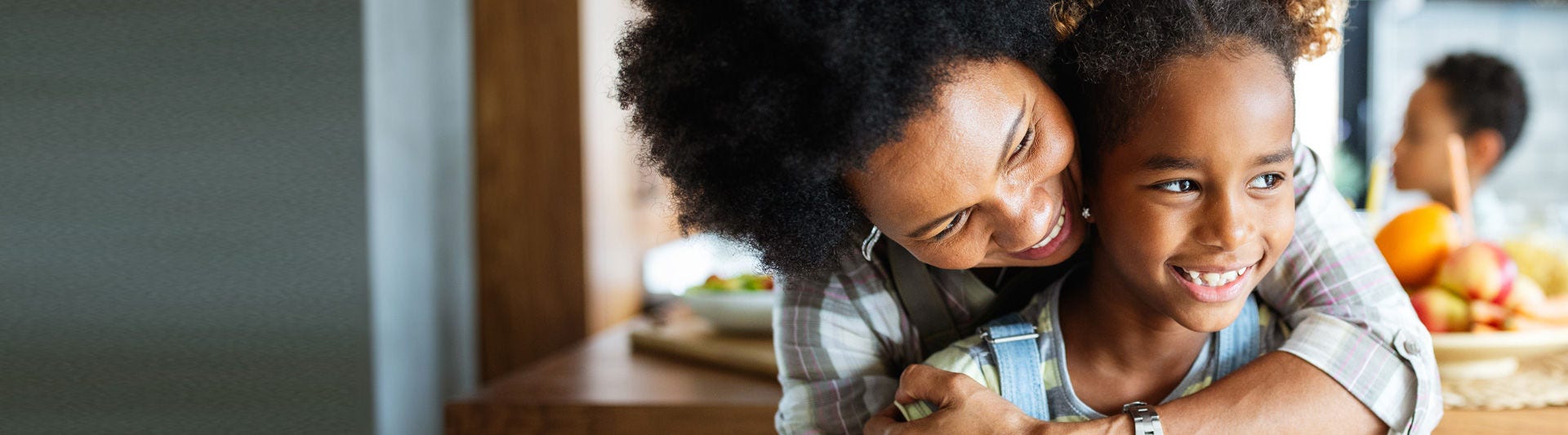 Portrait of a Small Family of a Mother, a Son and a Grandfather Watching TV Together in the Living Room. Family Generations Connecting and Bonding by Spending Time Together, Discussing and Having Fun