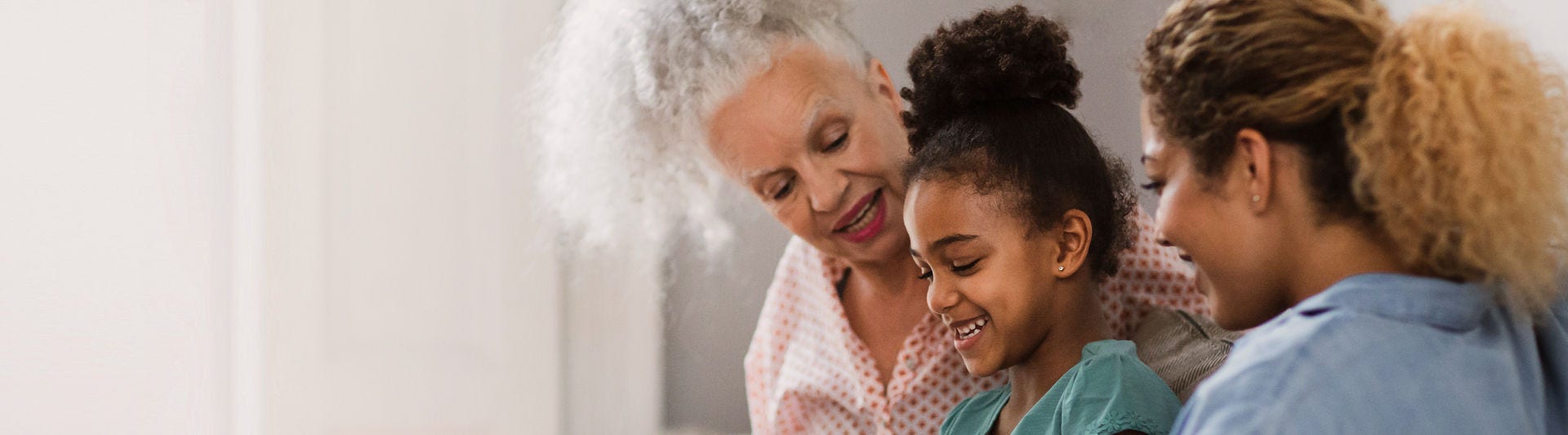 Granddaughter showing grandmother how to use smartphone
