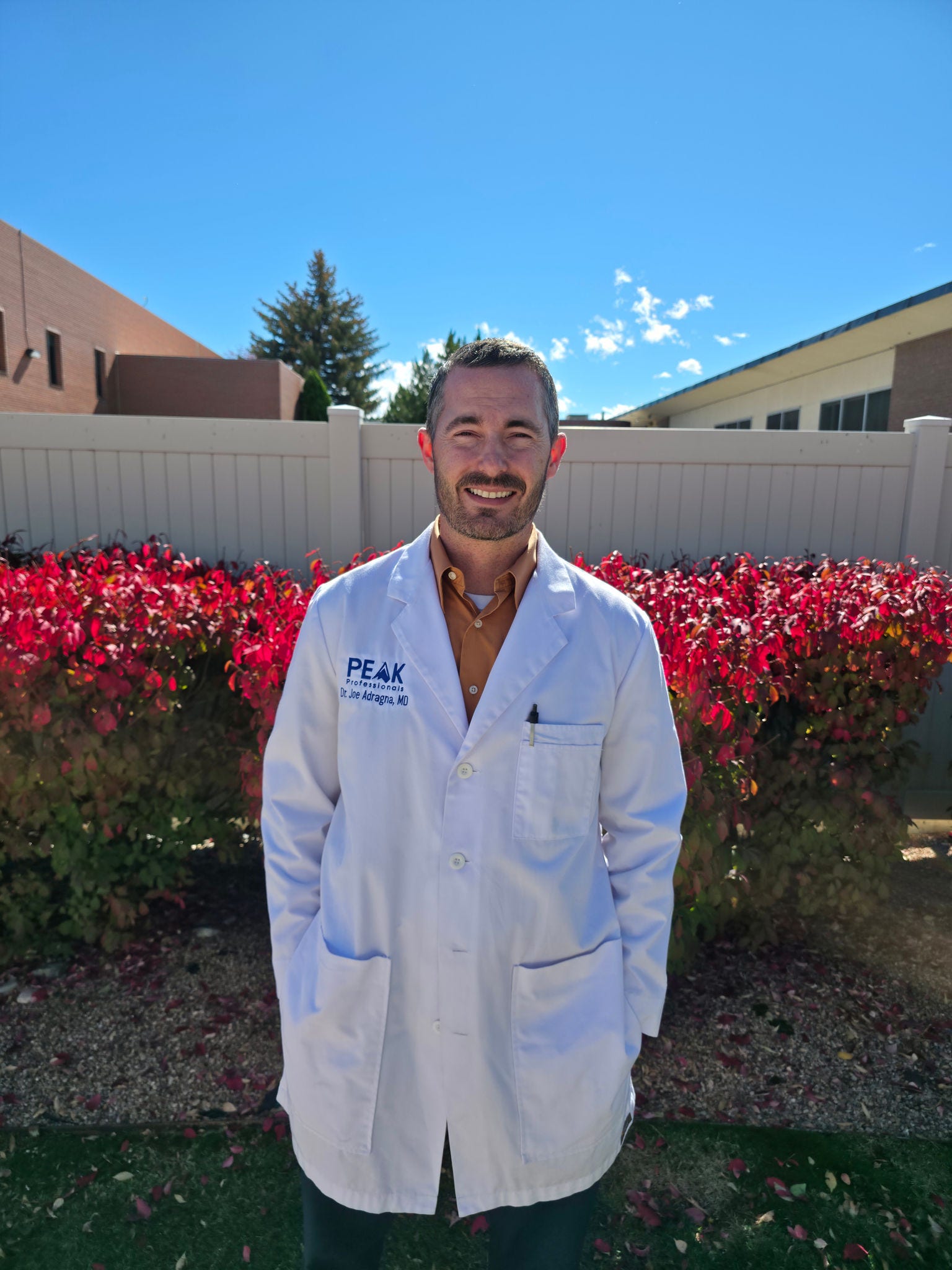 Dr. Joe smiling with flowers
